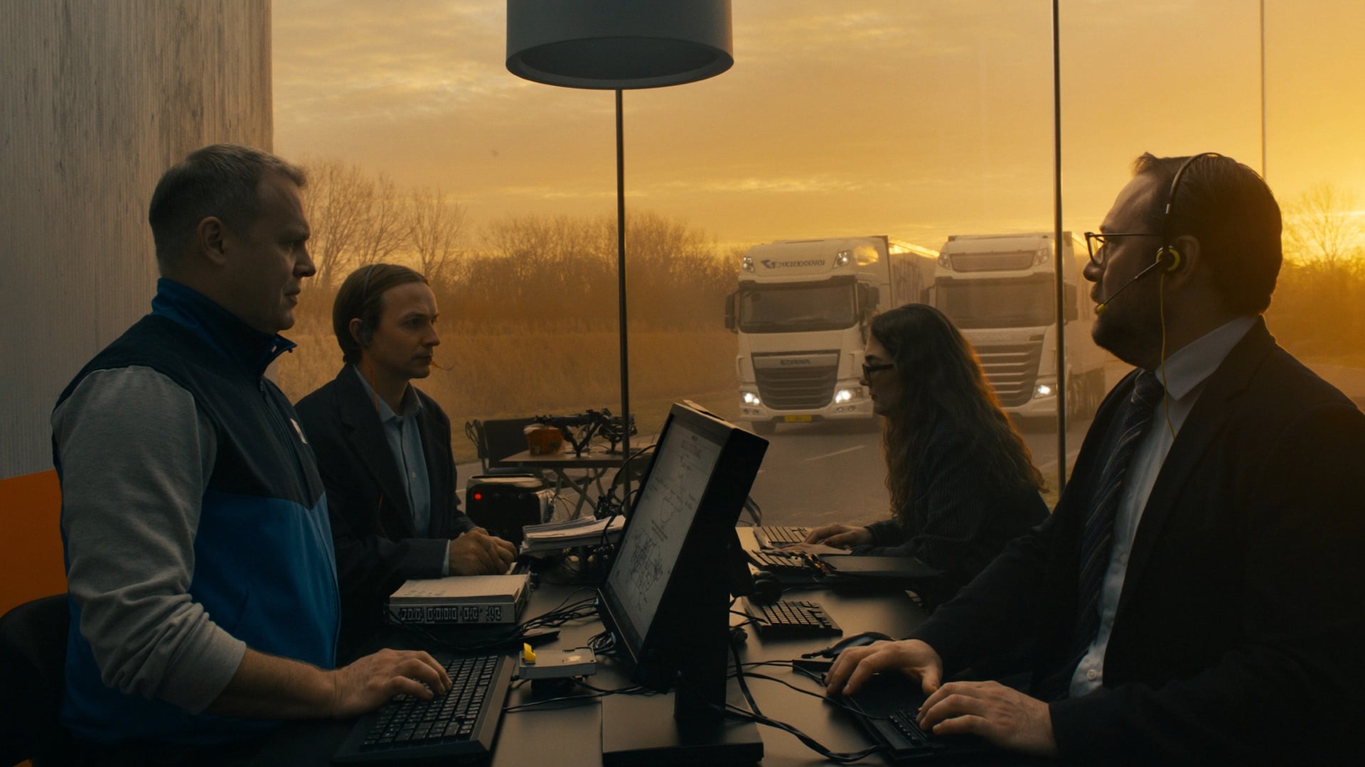 Fleet manager with headset reviewing profitability data at dawn, confident in the numbers before the day begins