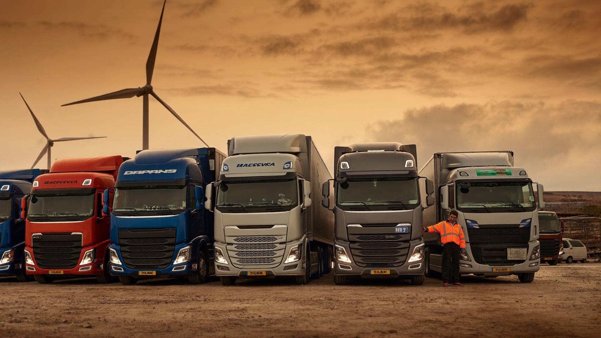 A fleet owner walking through the truck yard at dusk, surveying the fleet