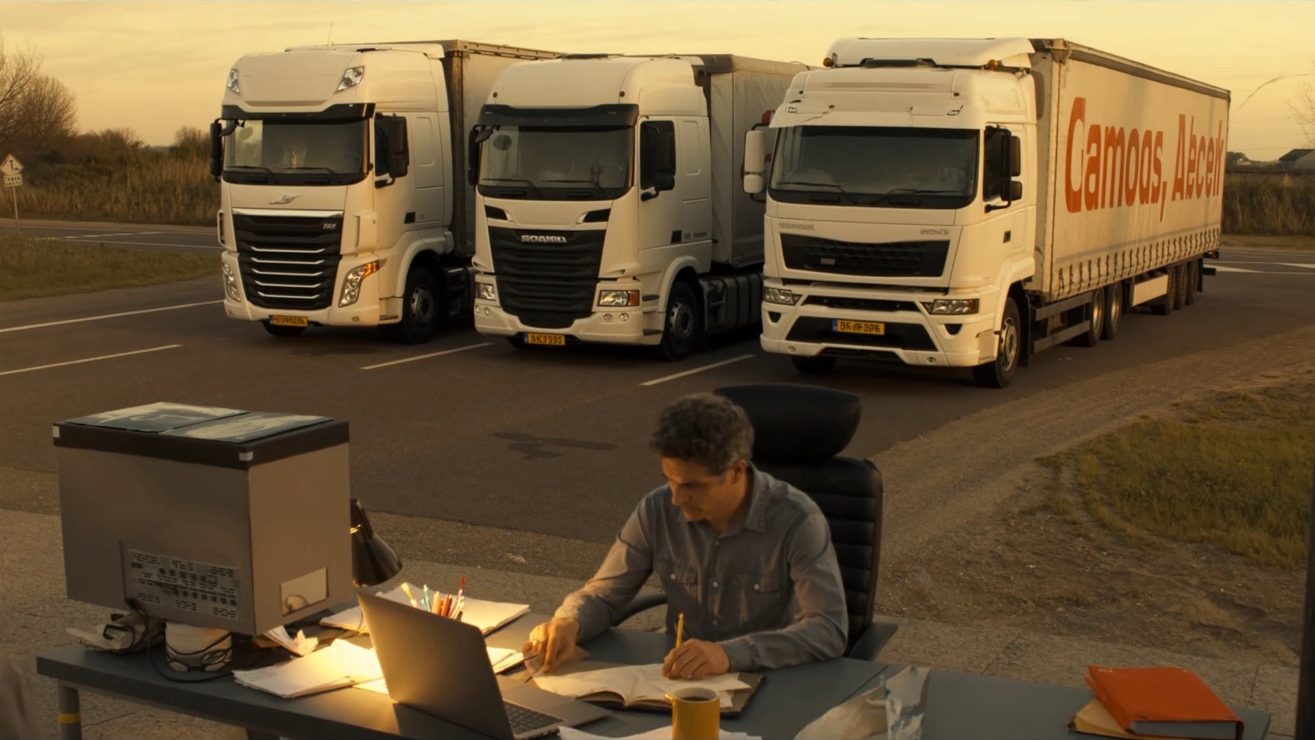 A back-office manager finishing payroll on a laptop late in the evening